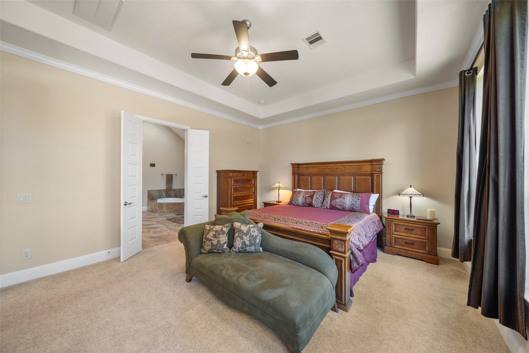 27626 South Colt Shadow Lane Spring, TX 77386 - Photo 20 of 50 a bedroom with a large bed and a chandelier