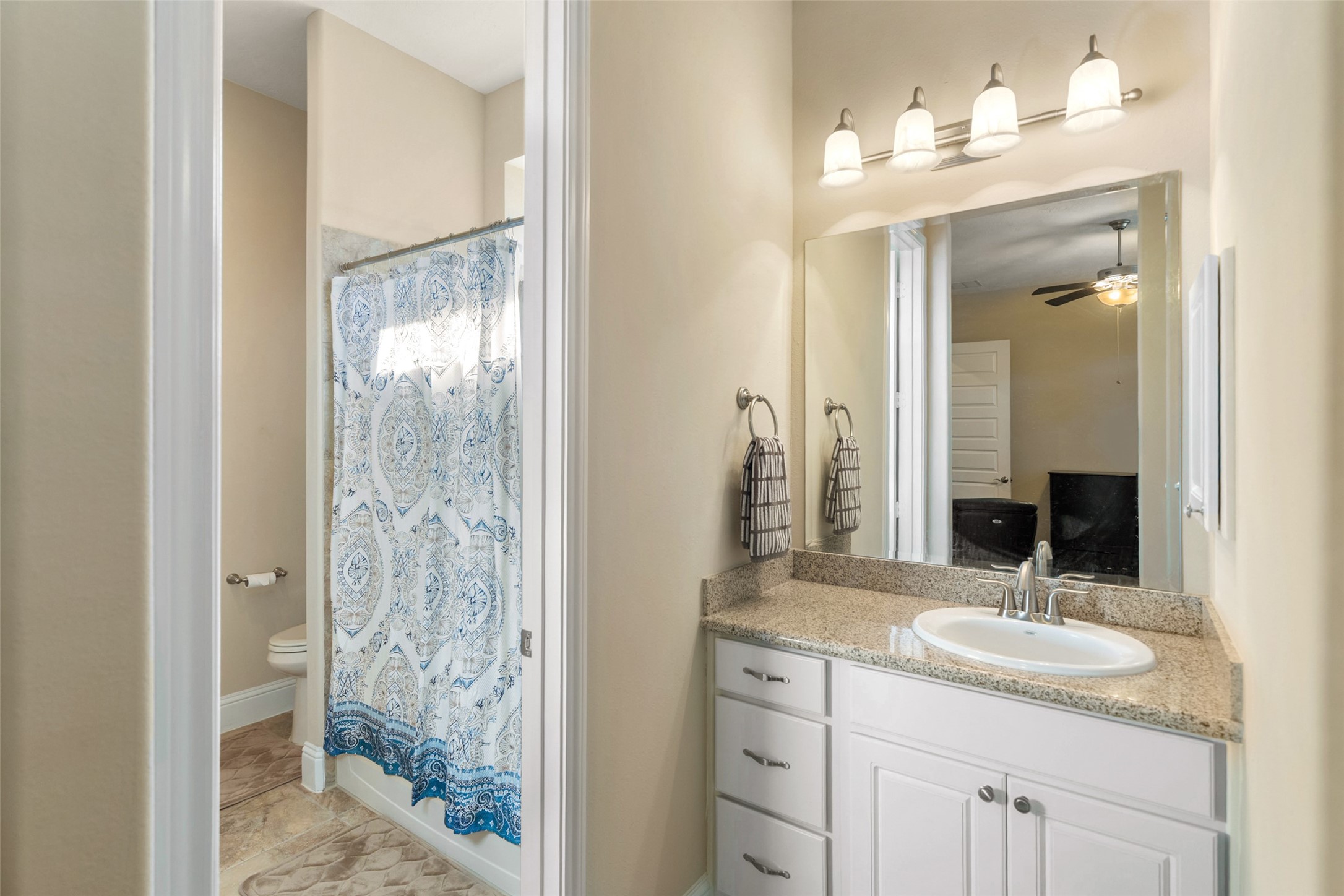 27626 South Colt Shadow Lane Spring, TX 77386 - Photo 29 of 50 a bathroom with a granite countertop sink and a mirror