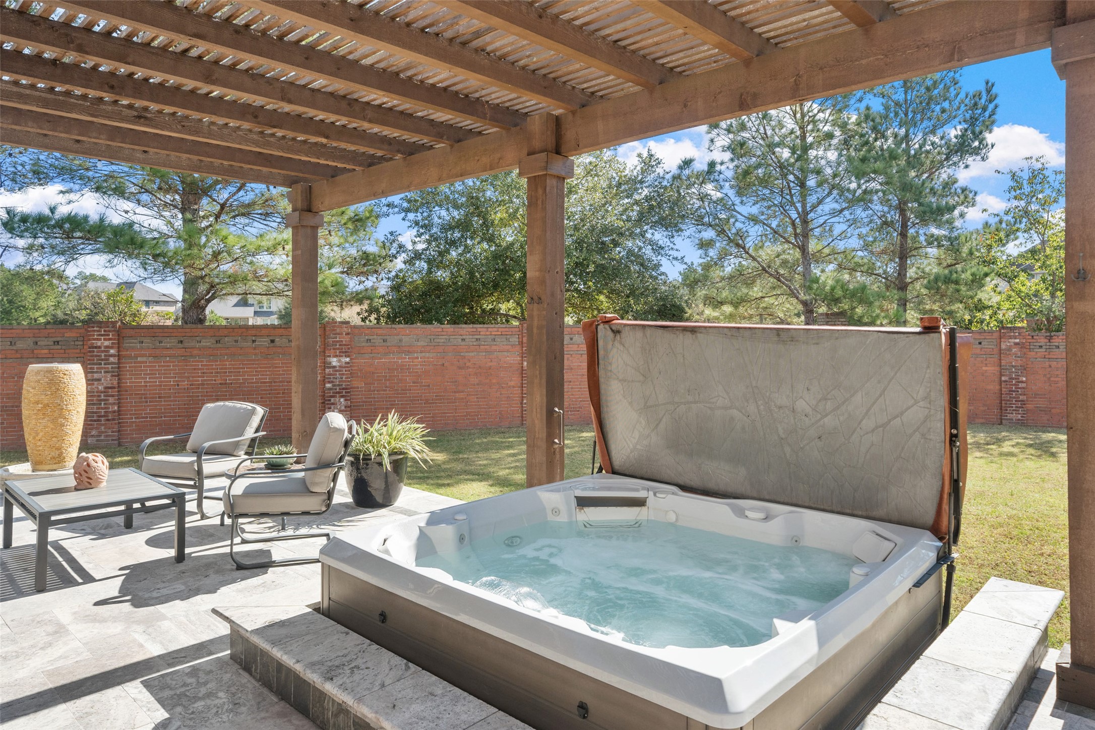 27626 South Colt Shadow Lane Spring, TX 77386 - Photo 38 of 50 a backyard of a house with a fountain table and chairs