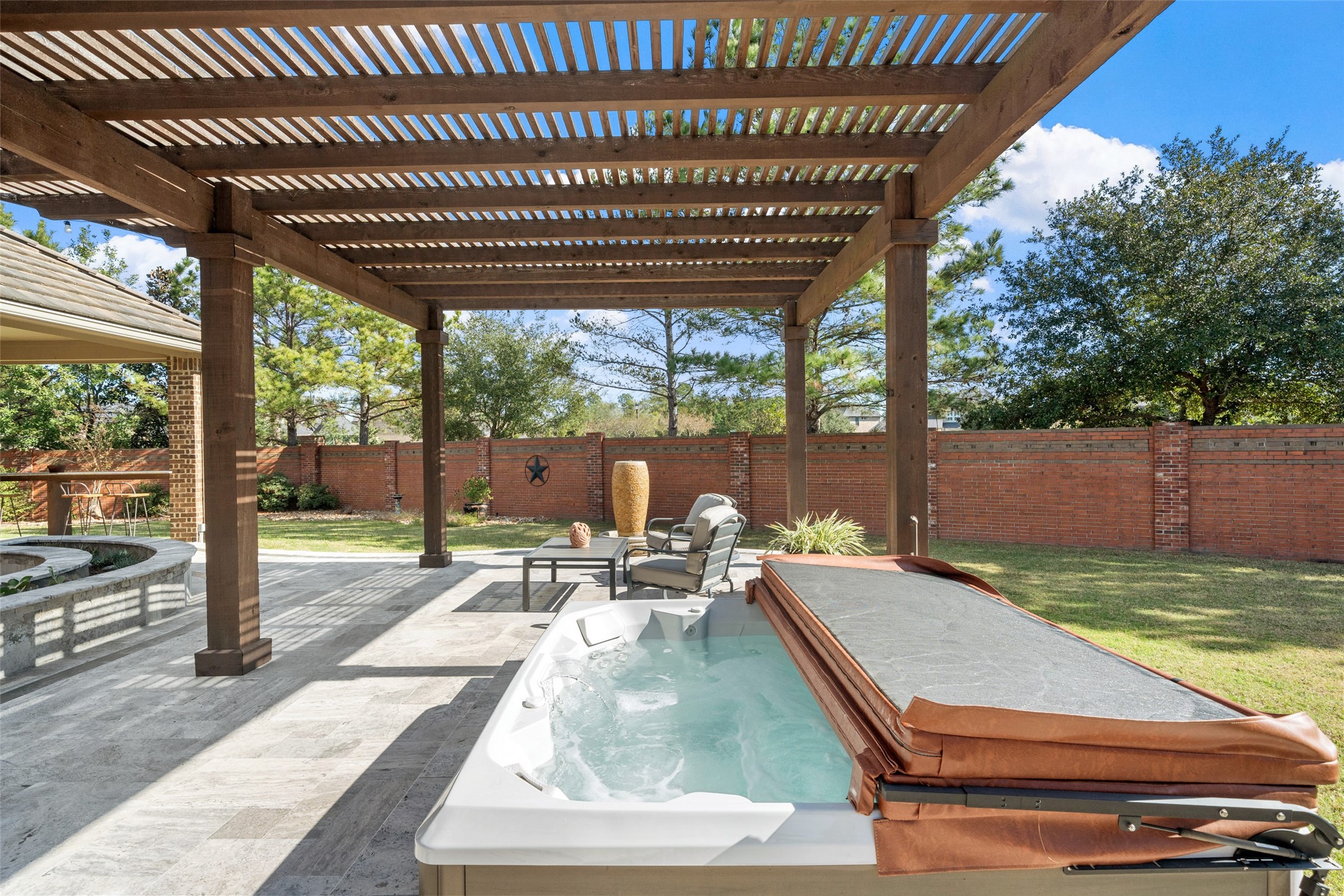 27626 South Colt Shadow Lane Spring, TX 77386 - Photo 40 of 50 a view of a patio with a table chairs and a backyard