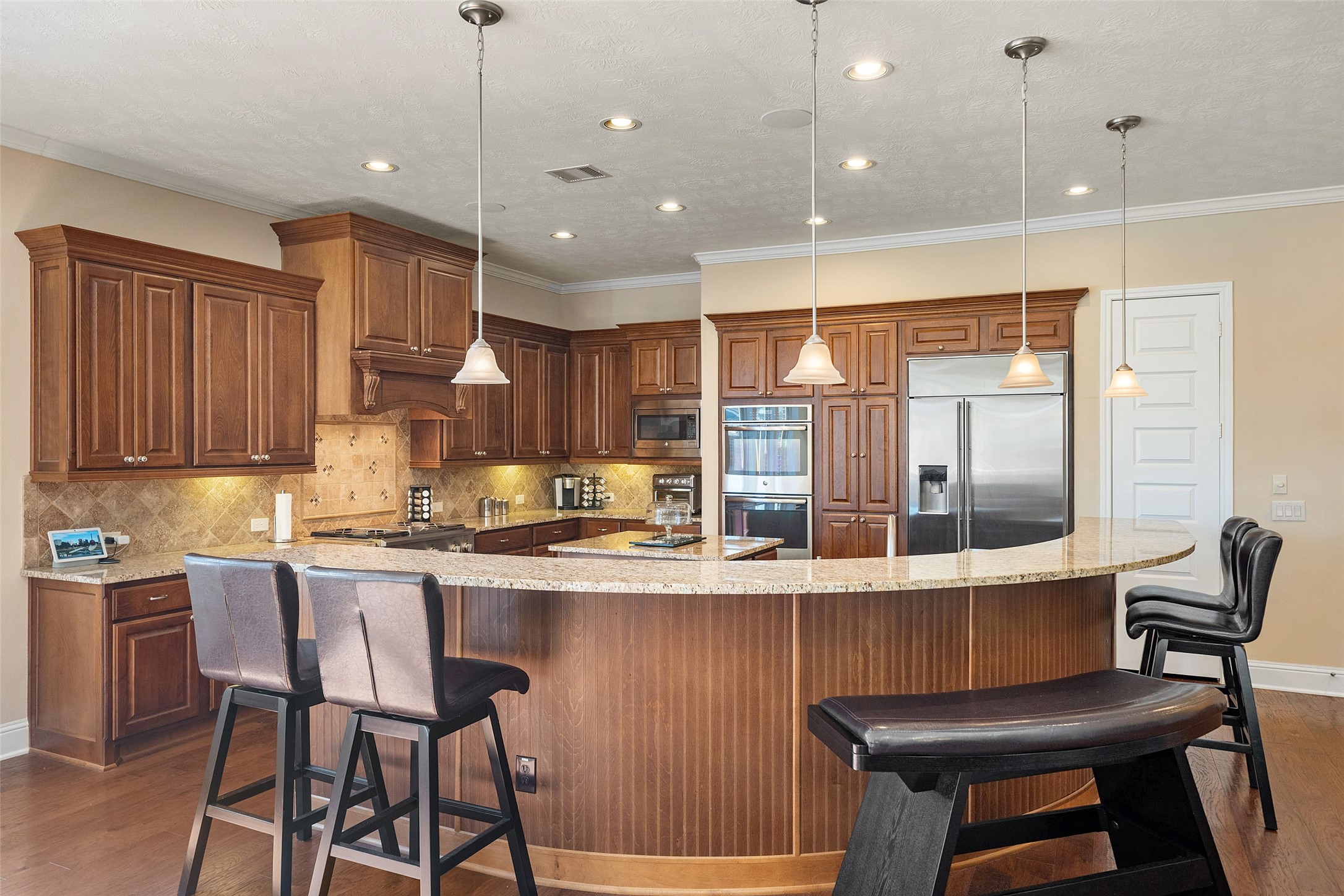 27626 South Colt Shadow Lane Spring, TX 77386 - Photo 8 of 50 a kitchen with kitchen island a large window and chairs