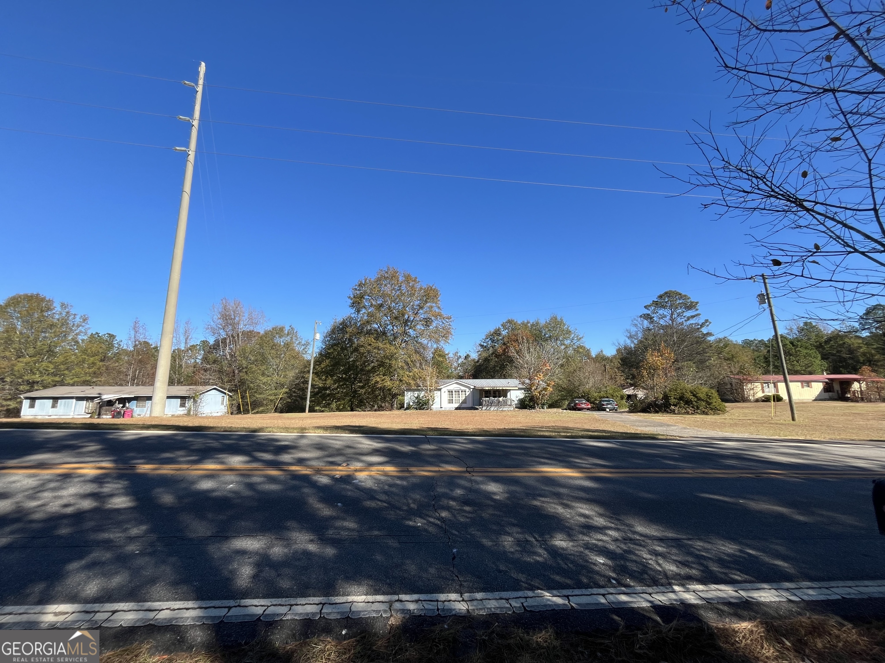 6326 Riggins Mill Road Dry Branch, GA 31020 - Photo 1 of 108 a view of a road with a building in the background