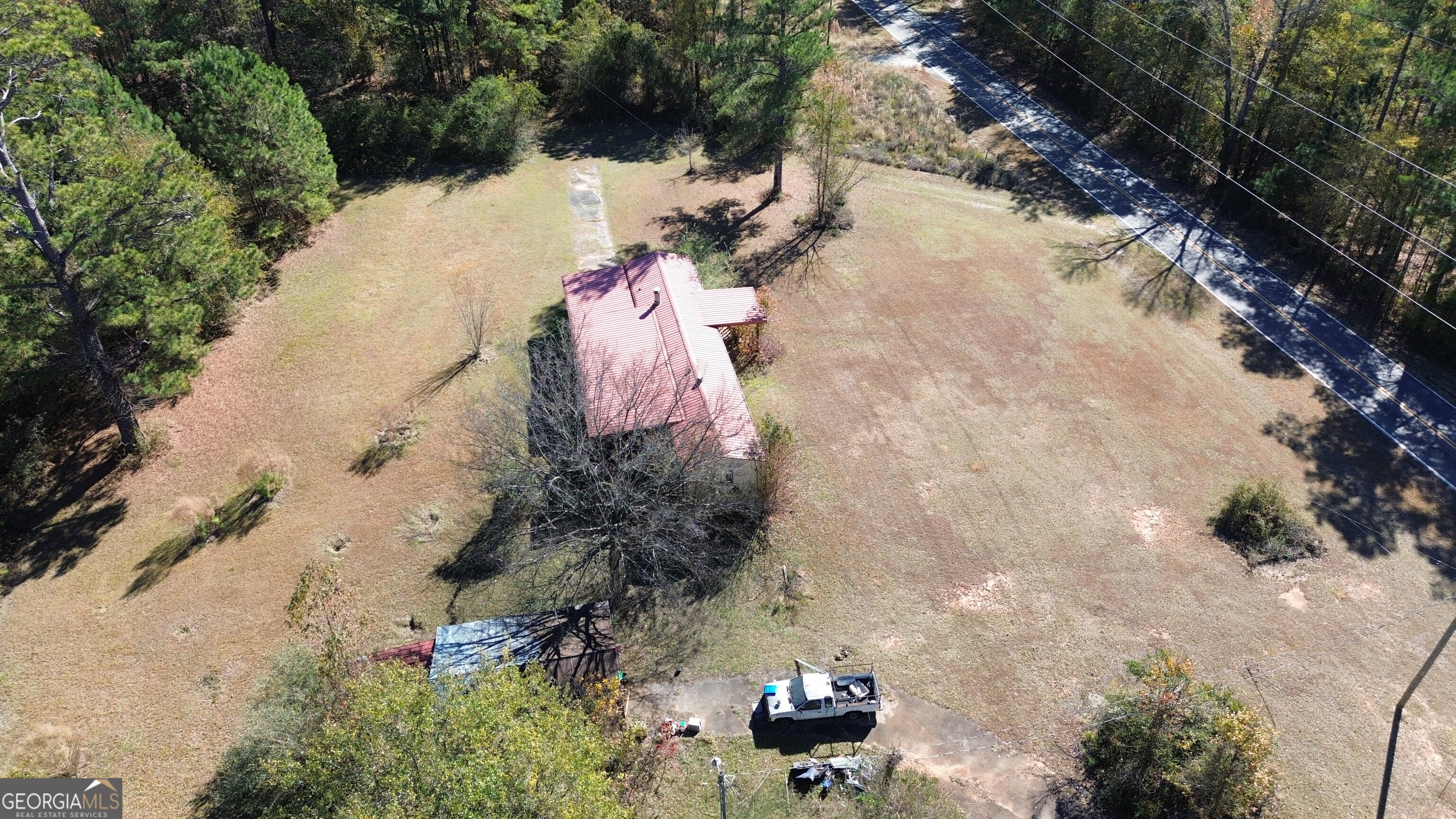 6326 Riggins Mill Road Dry Branch, GA 31020 - Photo 107 of 108 an aerial view of a house with a yard
