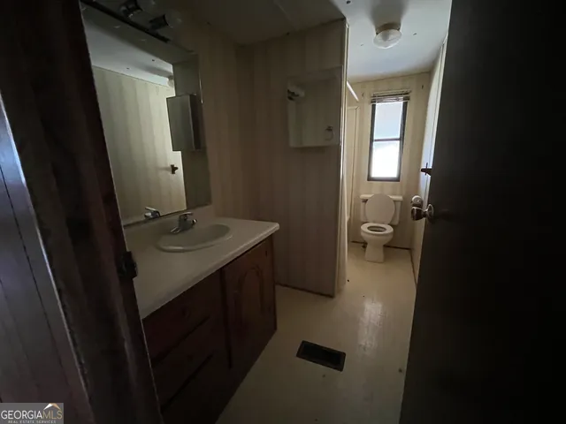 a front view of a house with a yard covered with snow