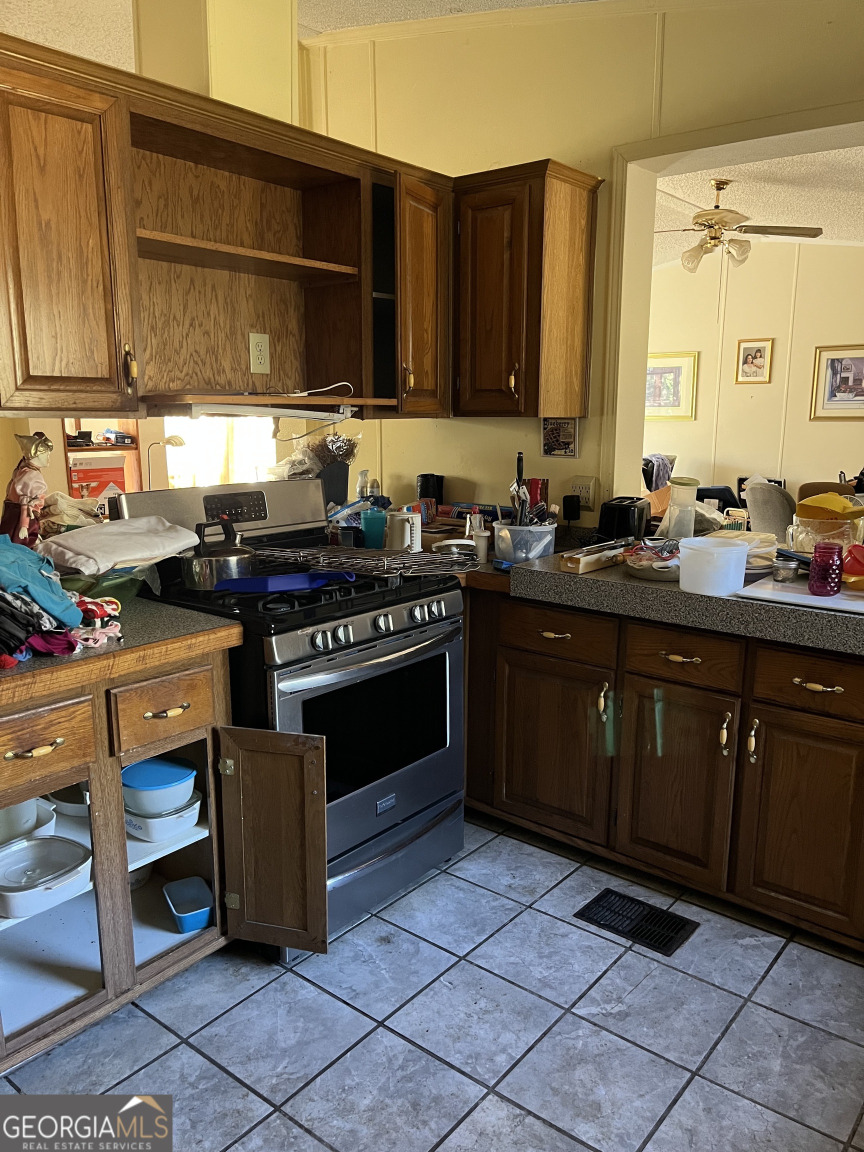 6326 Riggins Mill Road Dry Branch, GA 31020 - Photo 31 of 108 a kitchen with stainless steel appliances granite countertop a stove a sink and a microwave