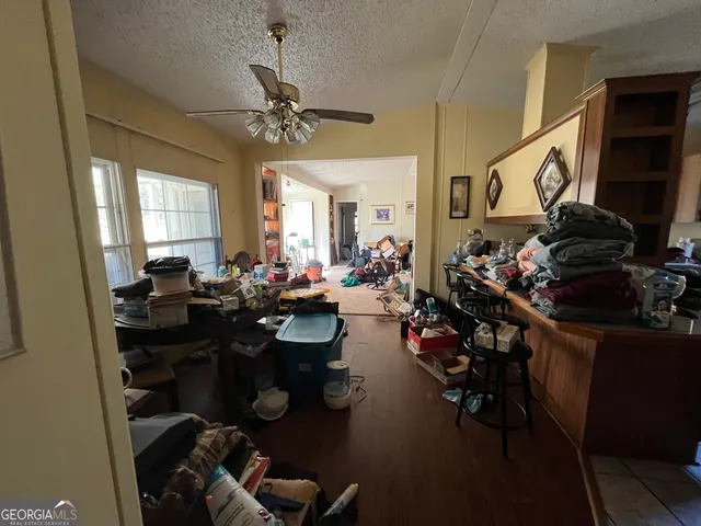 a living room with furniture a window and gym equipment
