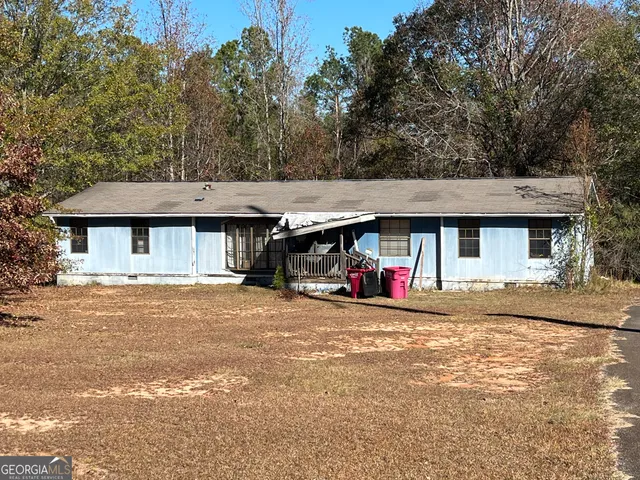 a view of a house with a yard and a bike