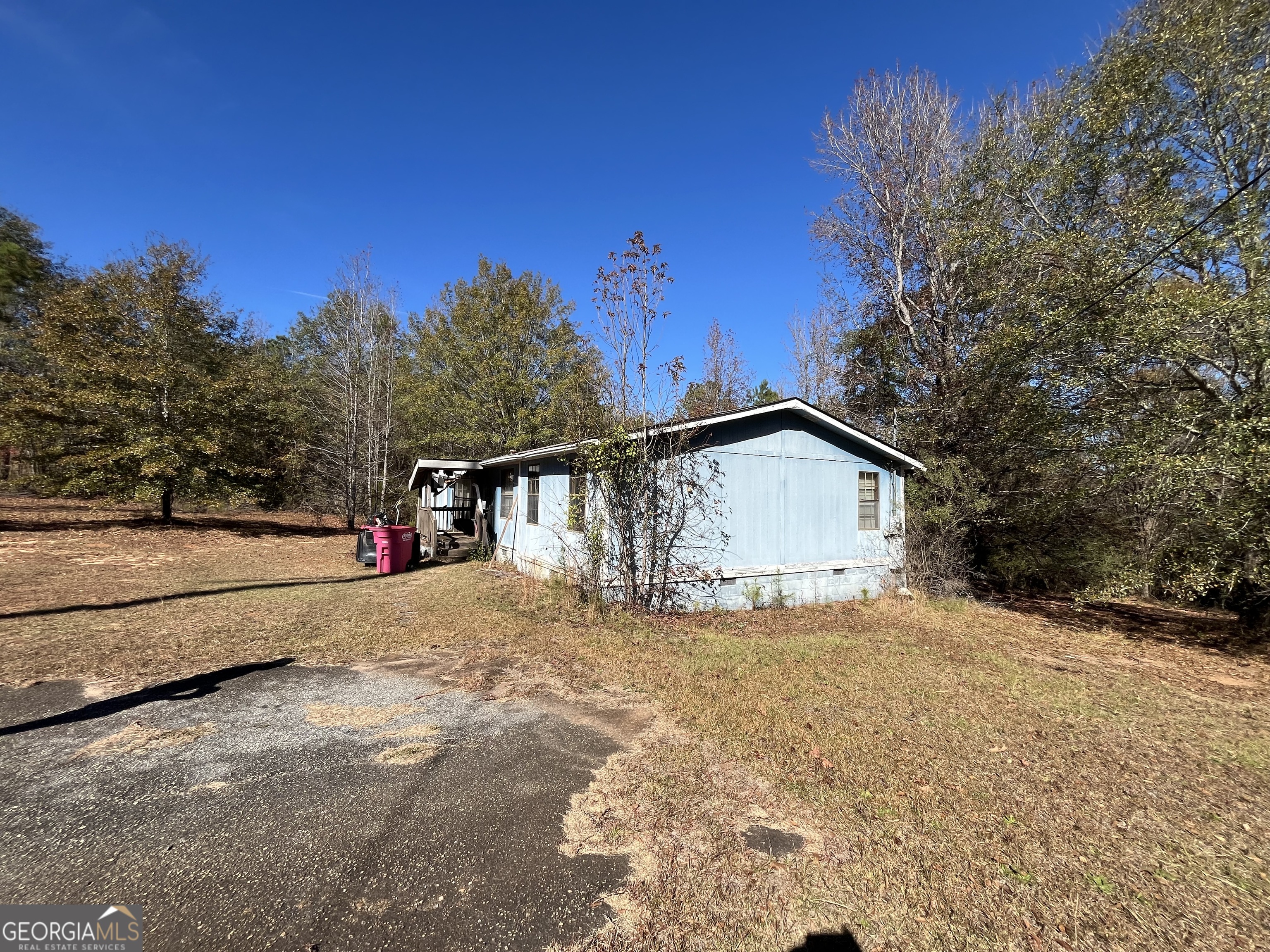 6326 Riggins Mill Road Dry Branch, GA 31020 - Photo 54 of 108 a house with trees in the background