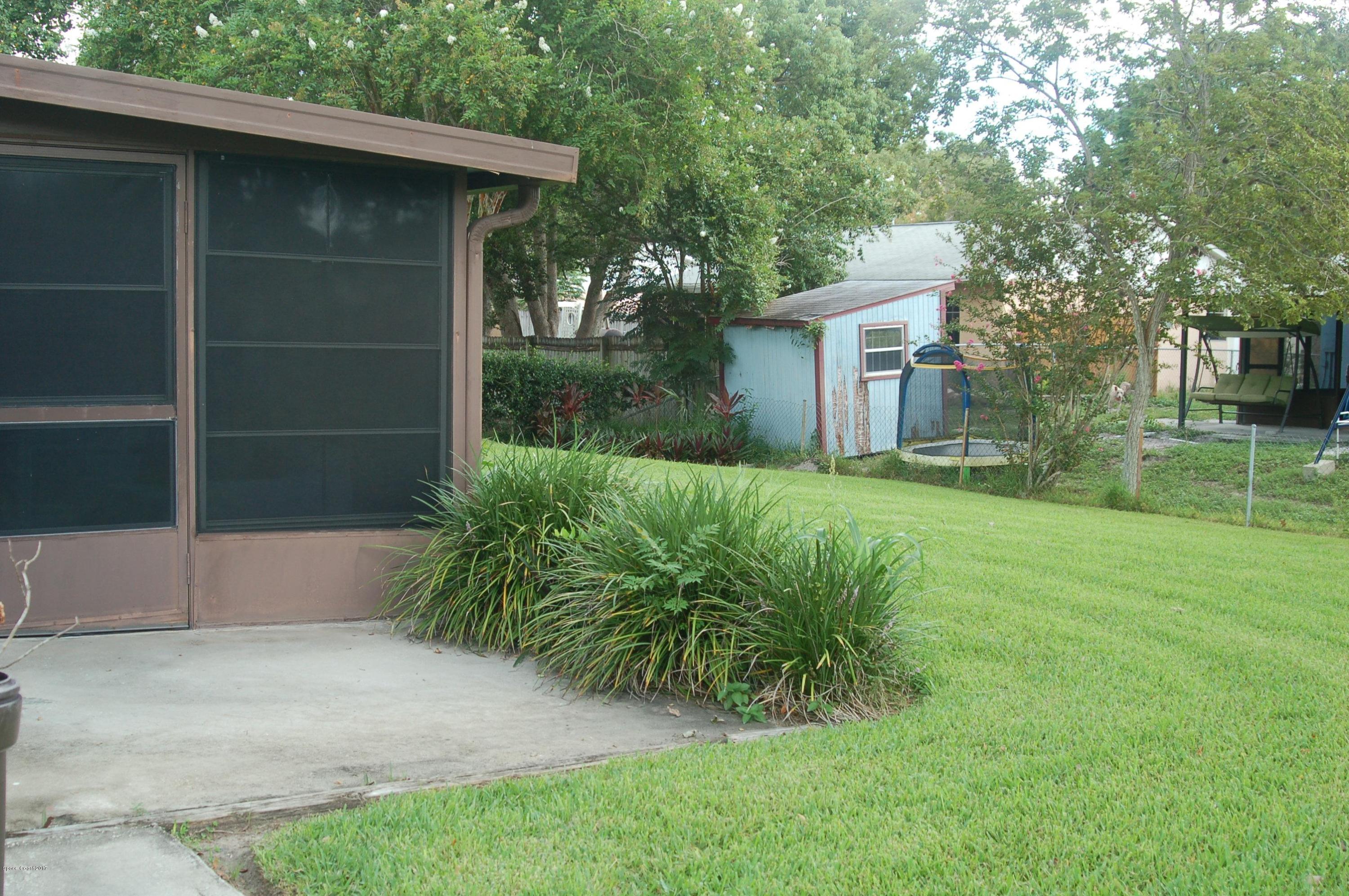 1557 West Powder Horn Road Titusville, FL 32796 - Photo 18 of 20 Side Back Patio