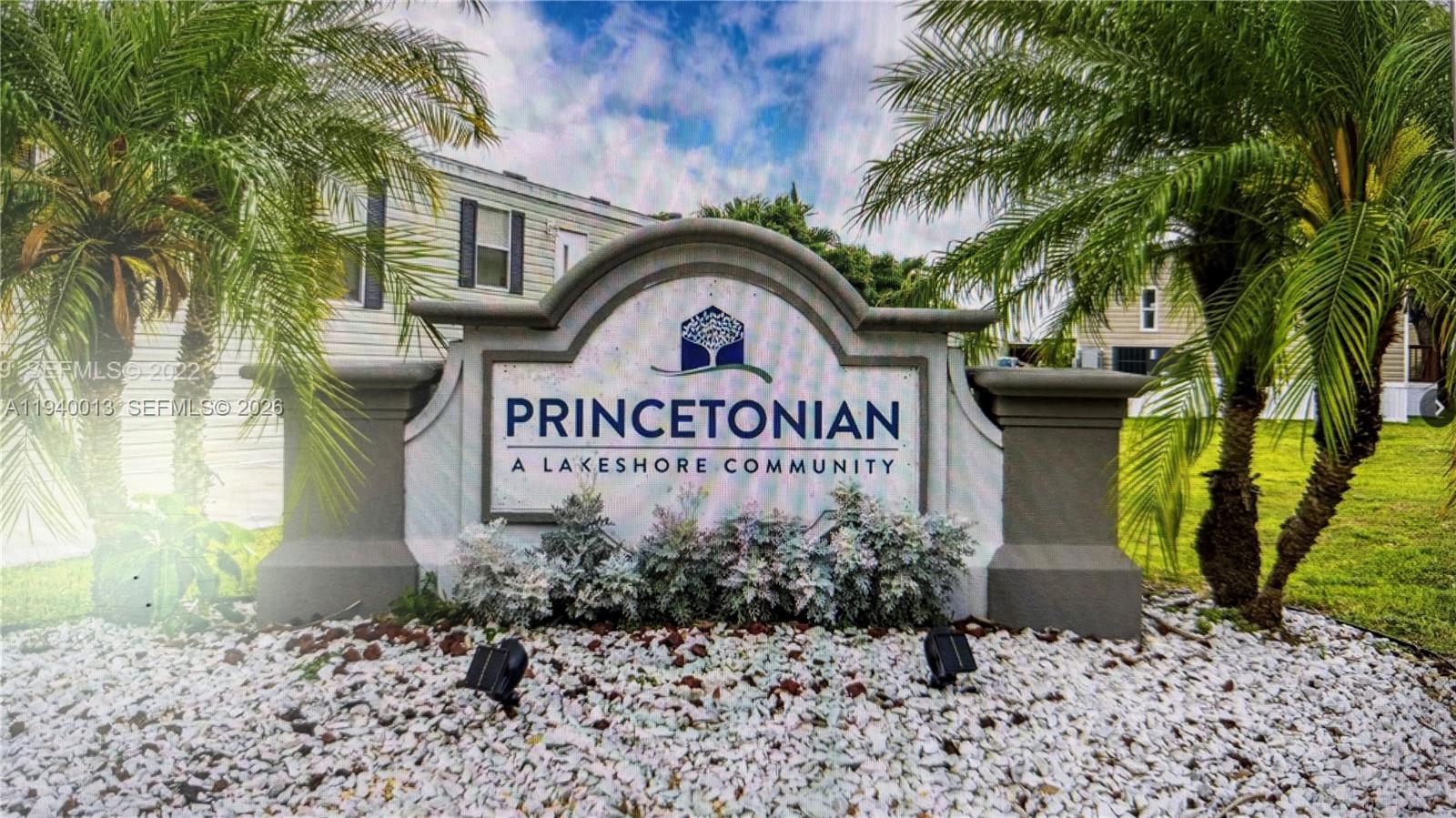 a front view of a house with garden and trees