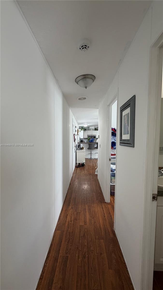 25345 Southwest 129th Place Homestead, FL 33032 - Photo 14 of 35 a view of a hallway with wooden floor and a living room