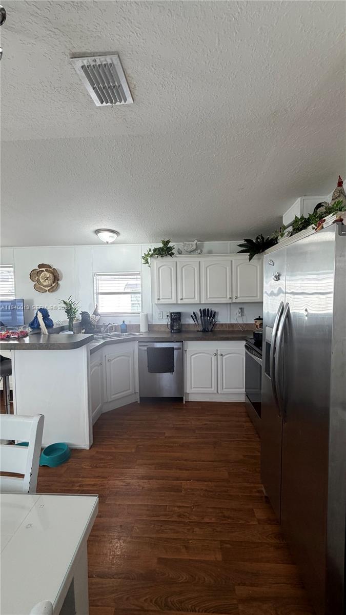 25345 Southwest 129th Place Homestead, FL 33032 - Photo 16 of 35 a kitchen with cabinets a sink and stainless steel appliances