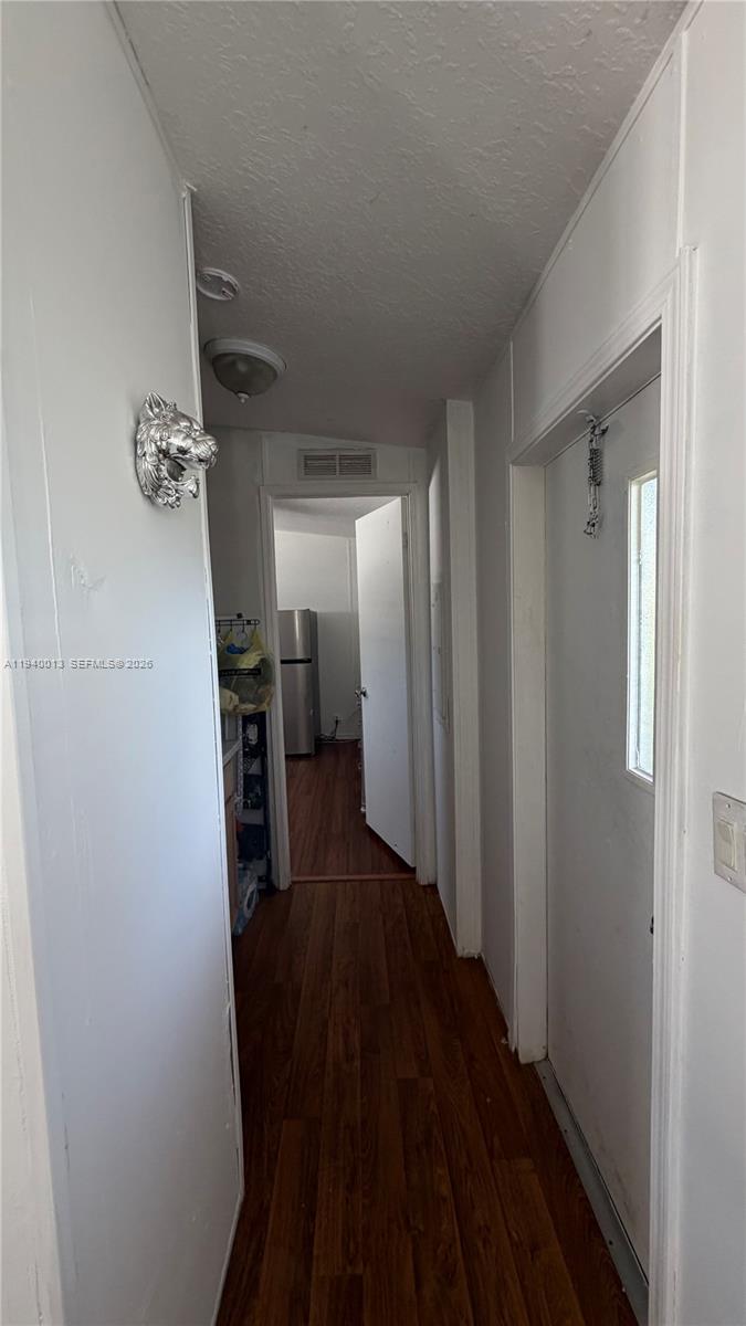 25345 Southwest 129th Place Homestead, FL 33032 - Photo 17 of 35 a view of a hallway with wooden floor and staircase