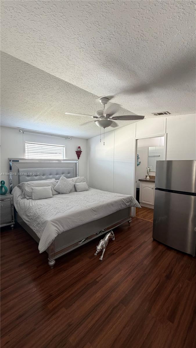 25345 Southwest 129th Place Homestead, FL 33032 - Photo 18 of 35 a spacious bedroom with a bed and wooden floor
