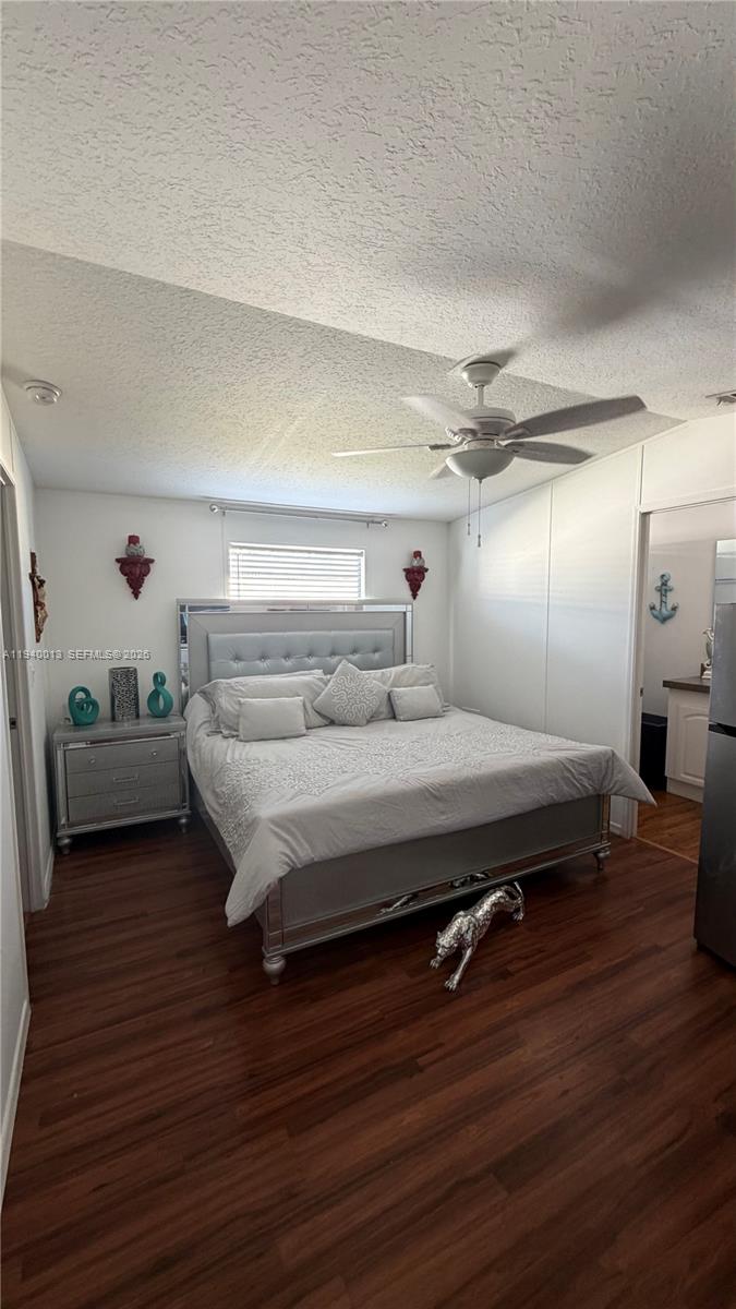 25345 Southwest 129th Place Homestead, FL 33032 - Photo 22 of 35 a spacious bedroom with a bed and a wooden floor