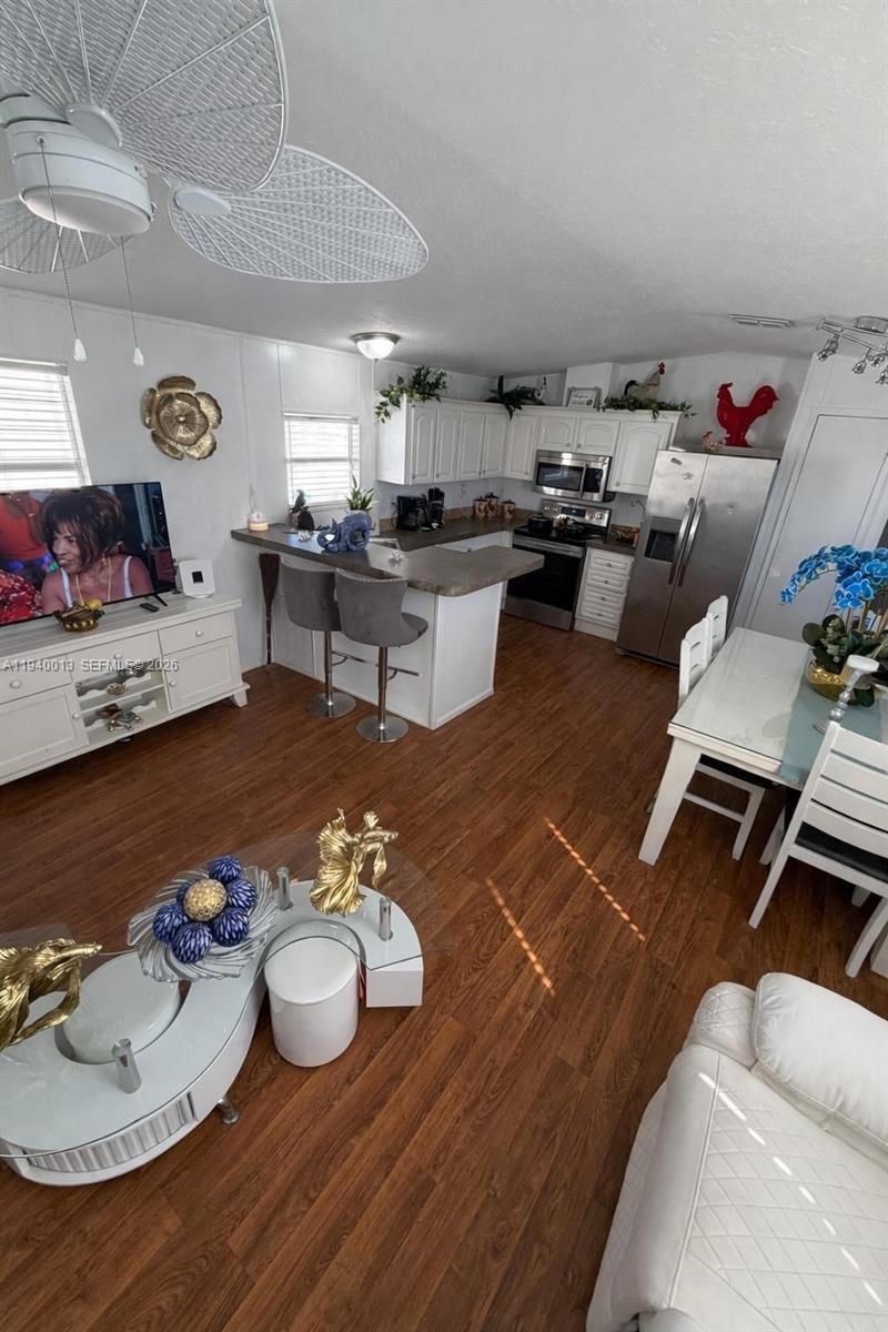 25345 Southwest 129th Place Homestead, FL 33032 - Photo 30 of 35 a living room with furniture and a wooden floor