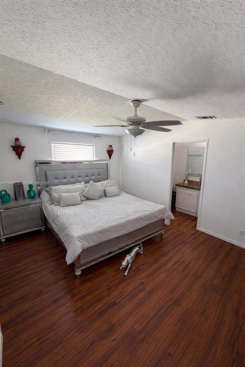 25345 Southwest 129th Place Homestead, FL 33032 - Photo 31 of 35 a bedroom with a bed and wooden floor