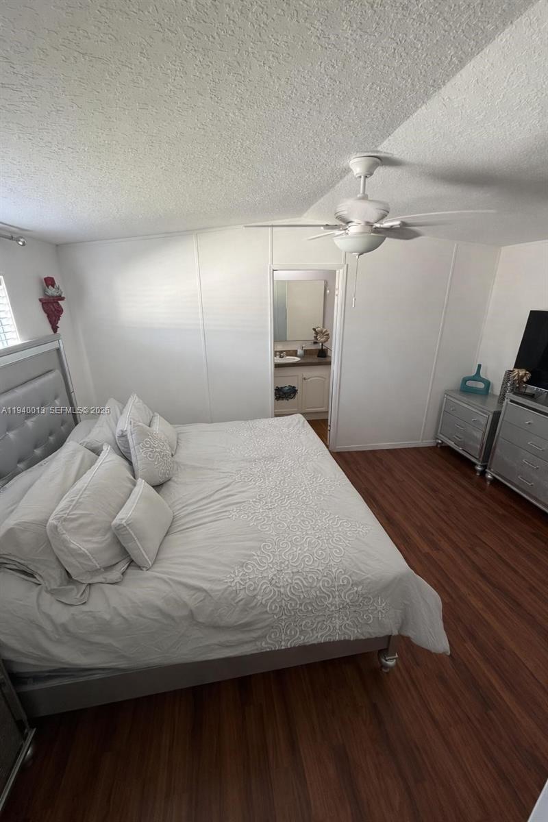 25345 Southwest 129th Place Homestead, FL 33032 - Photo 35 of 35 a bedroom with a bed and a chandelier