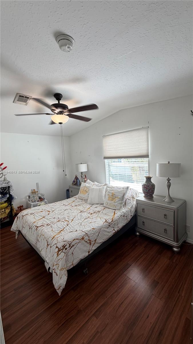 25345 Southwest 129th Place Homestead, FL 33032 - Photo 8 of 35 a bedroom with a bed and wooden floor