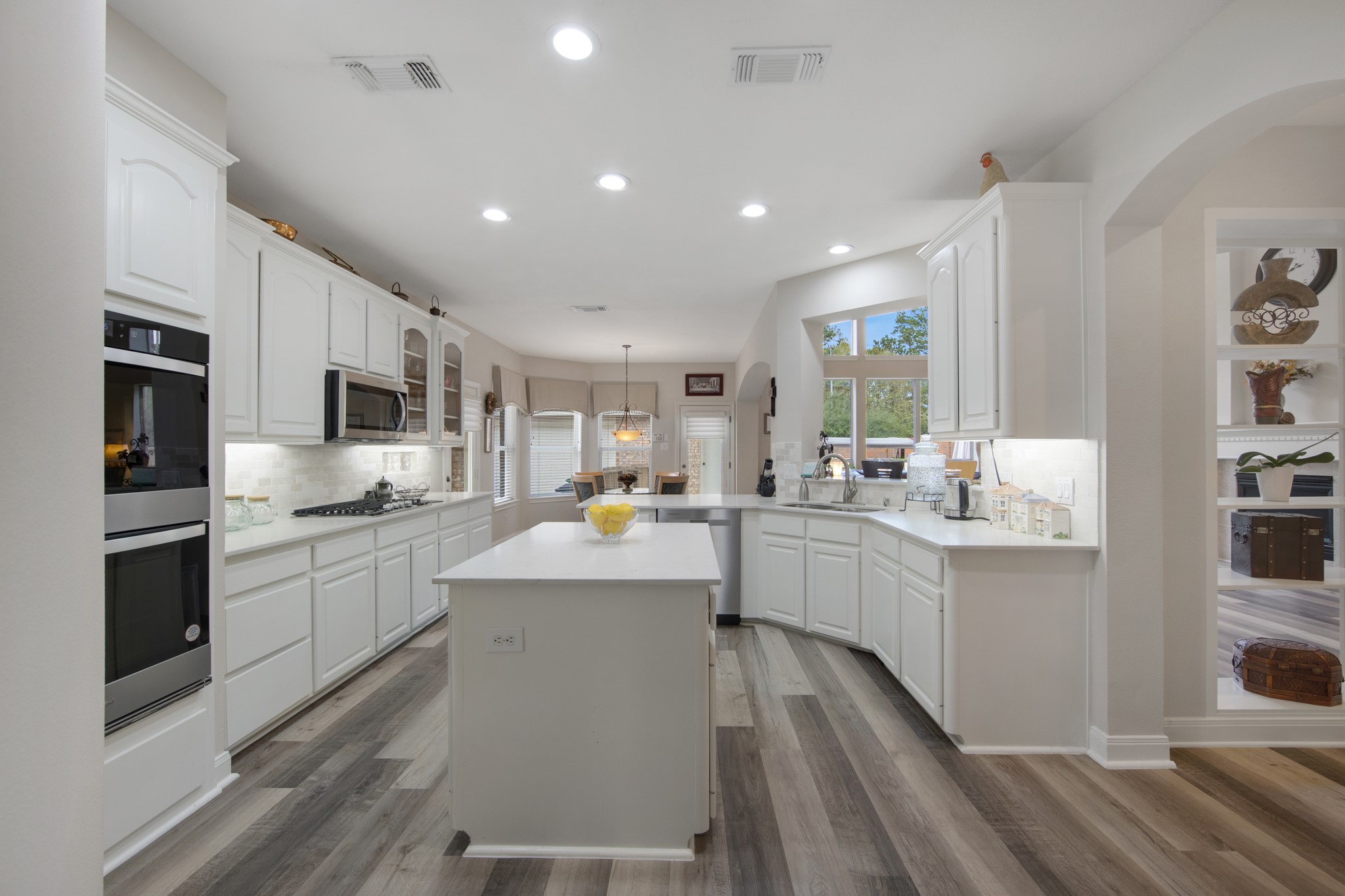 9510 Ashdown Forest Drive Spring, TX 77379 - Photo 15 of 50 a kitchen with counter top space a sink cabinets and stainless steel appliances