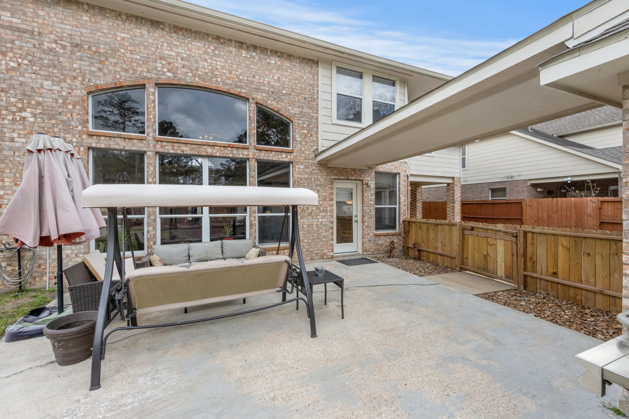 9510 Ashdown Forest Drive Spring, TX 77379 - Photo 43 of 50 a view of a house with a large window and wooden fence