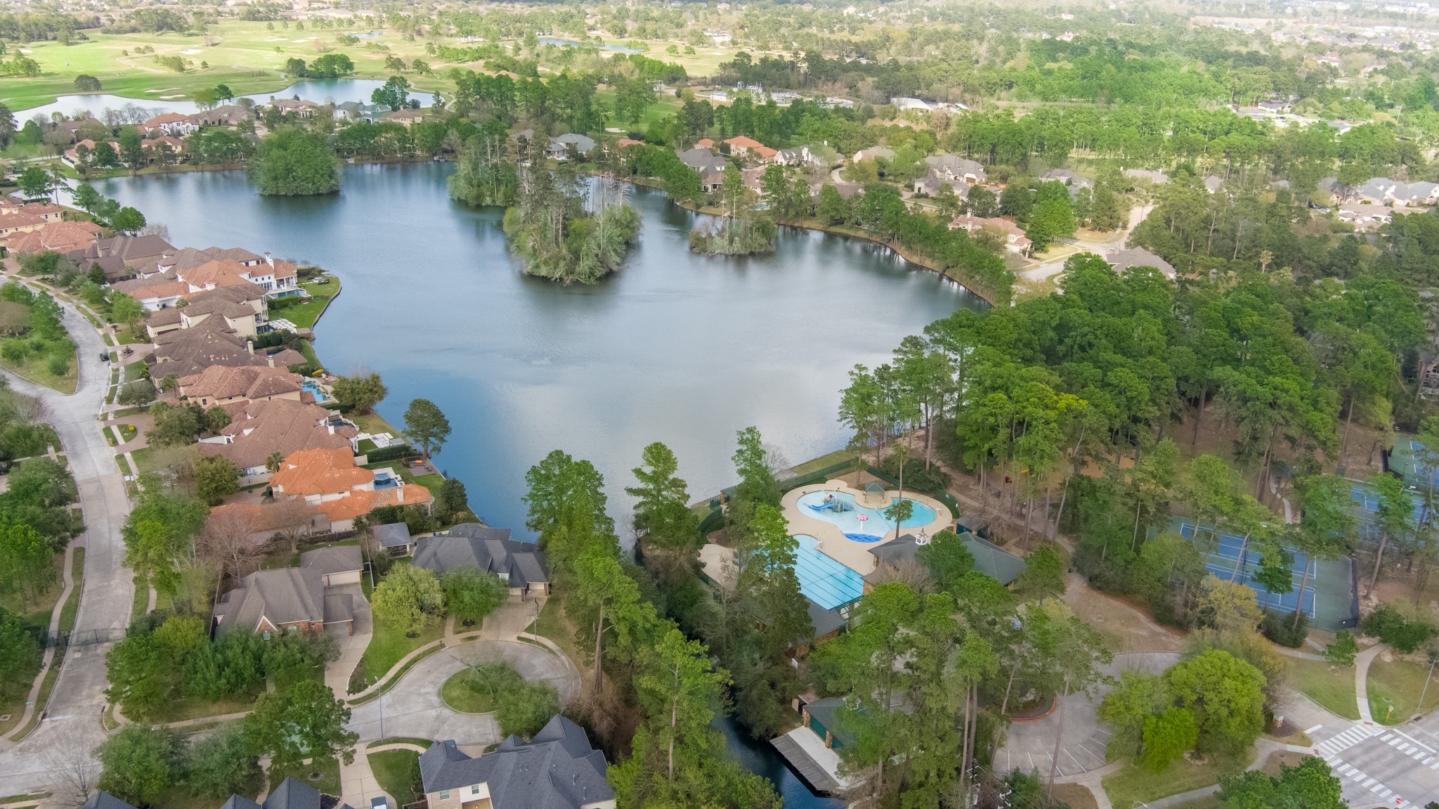 9510 Ashdown Forest Drive Spring, TX 77379 - Photo 44 of 50 AERIAL VIEW – aerial perspective showcasing the surrounding neighborhood and nearby lake. The community features beautiful wooded areas and scenic surroundings.