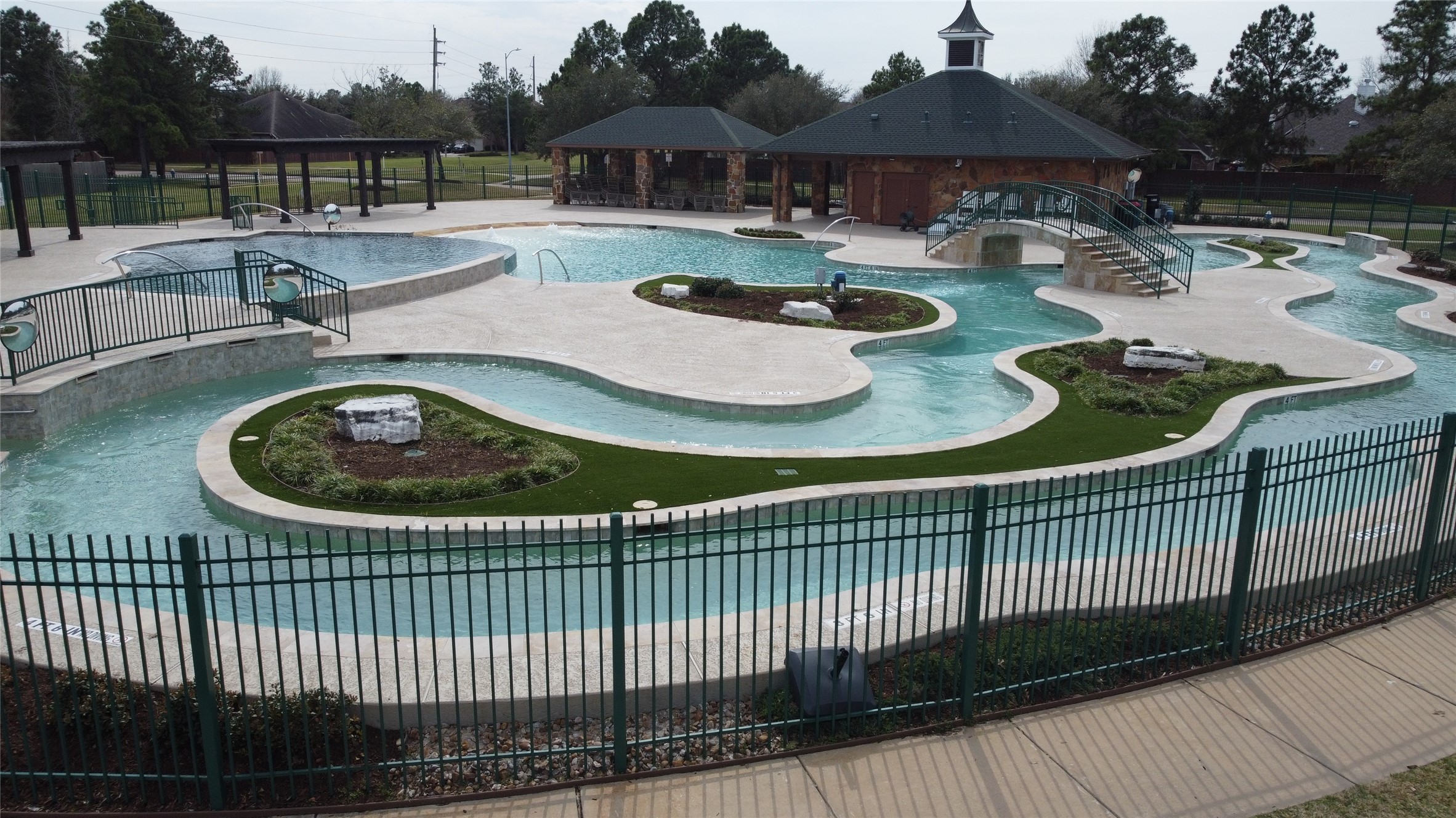 9510 Ashdown Forest Drive Spring, TX 77379 - Photo 45 of 50 COMMUNITY POOL/LAZY RIVER – resort-style community pool with multiple water features and gathering areas for residents. A perfect place to cool off and relax during the summer months.