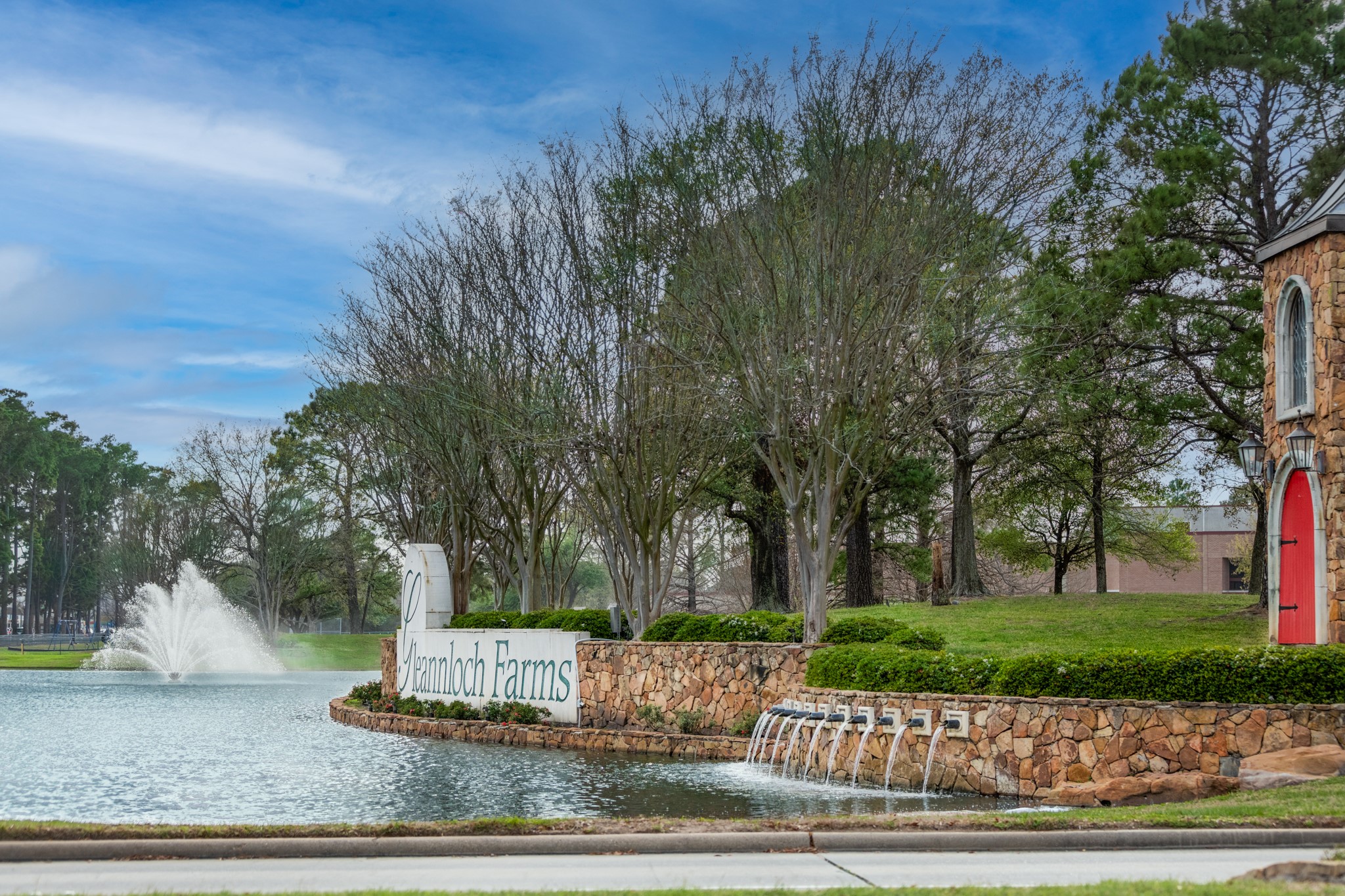 9510 Ashdown Forest Drive Spring, TX 77379 - Photo 50 of 50 COMMUNITY ENTRANCE – welcoming entrance to the neighborhood featuring landscaped grounds, water features, and beautiful stone accents.