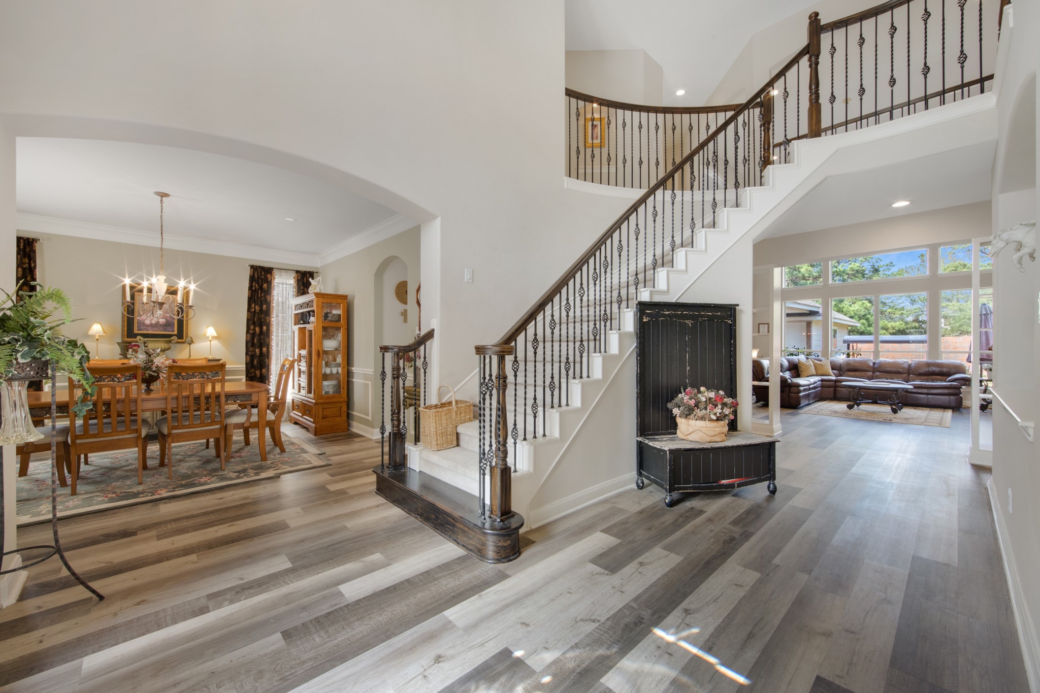 9510 Ashdown Forest Drive Spring, TX 77379 - Photo 9 of 50 FOYER – dramatic two-story entry with sweeping staircase and elegant iron balusters creates an impressive welcome. The open design offers beautiful sightlines into the dining room and main living areas while natural light fills the space.