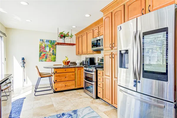 a kitchen with a refrigerator and a stove