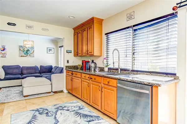 a living room with granite countertop furniture and a kitchen sink