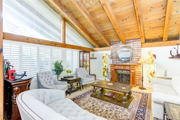 a living room with furniture a rug and a fireplace