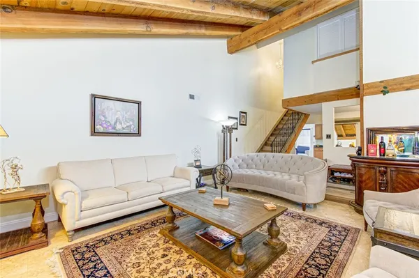 a living room with furniture and a book shelf