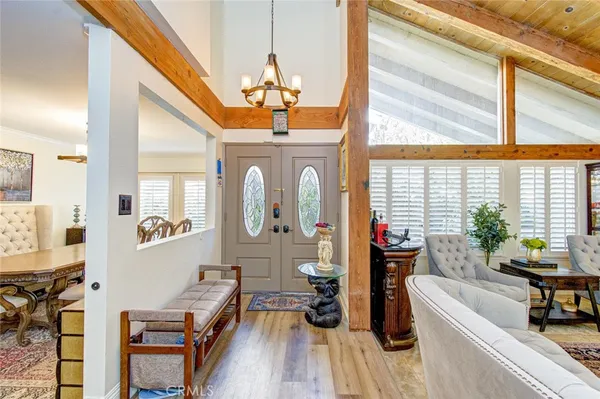 a very nice looking room with many windows and furniture