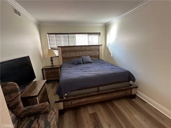 a bedroom with a bed chair and window