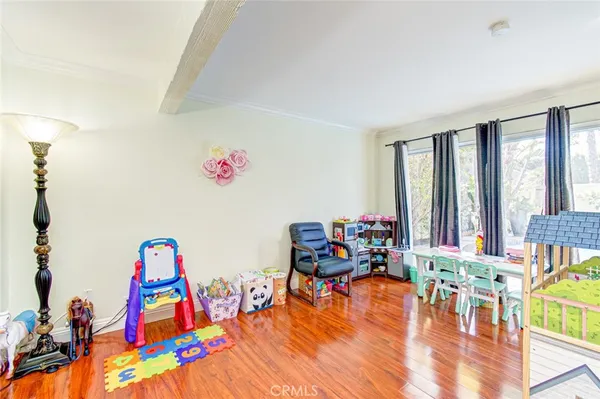 a living room with furniture and floor to ceiling windows