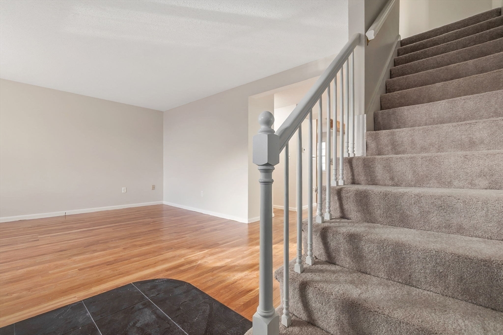 320 Newbury Street, Unit 304 Danvers, MA 01923 - Photo 22 of 32 a view of livingroom with furniture and stairs