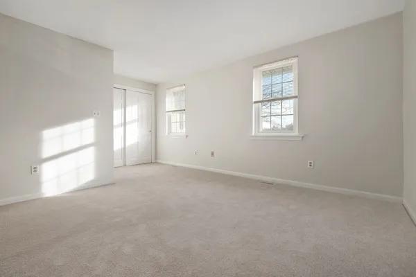 a view of an empty room and a window