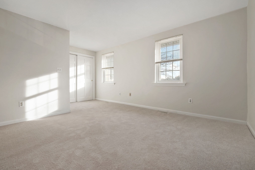 320 Newbury Street, Unit 304 Danvers, MA 01923 - Photo 26 of 32 an empty room with windows