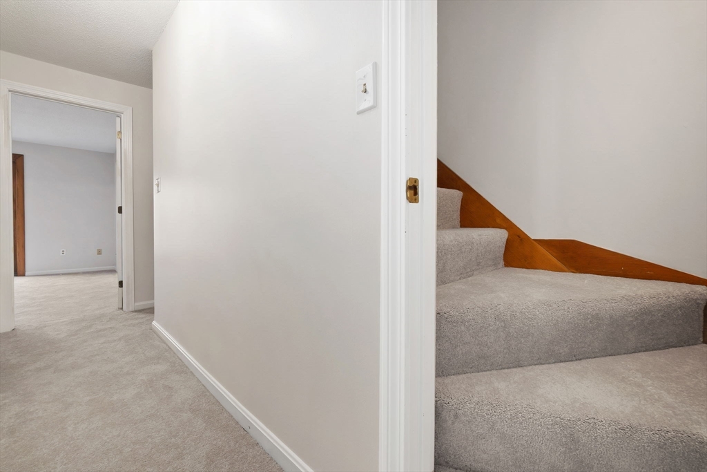 320 Newbury Street, Unit 304 Danvers, MA 01923 - Photo 28 of 32 a view of a hallway with staircase