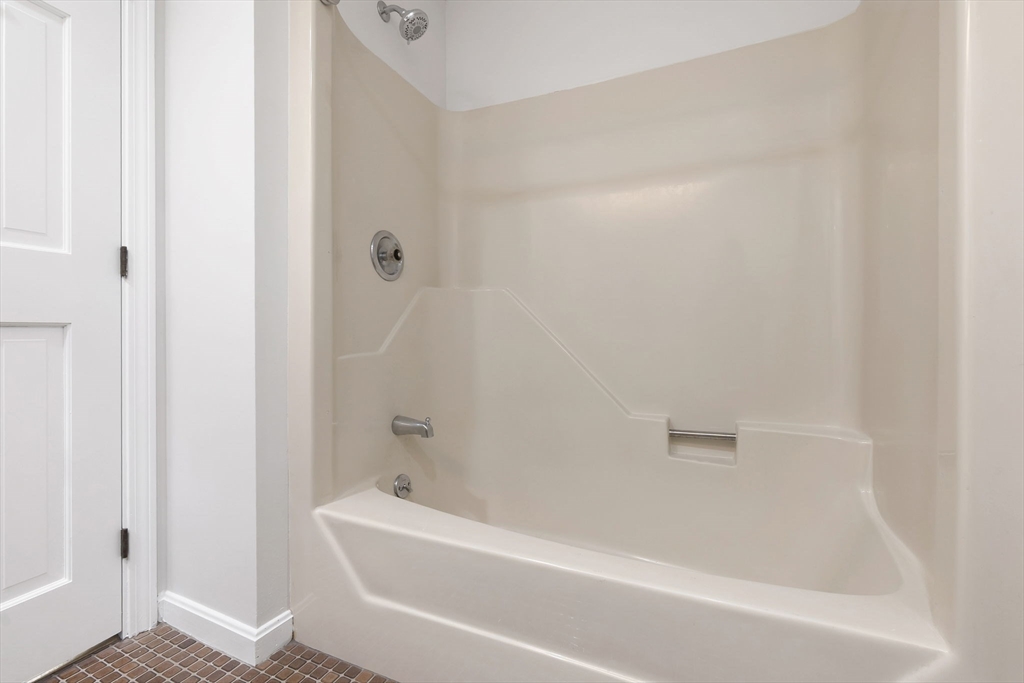 320 Newbury Street, Unit 304 Danvers, MA 01923 - Photo 32 of 32 a bathroom with a bathtub