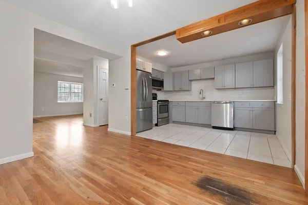 a view of a kitchen with wooden floor and a sink