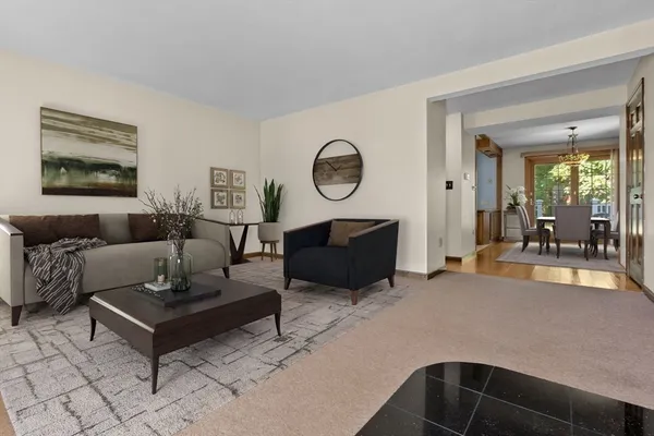 a living room with furniture window and a potted plant