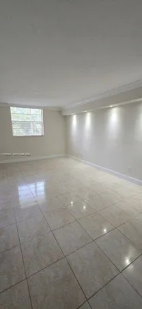 a kitchen with a refrigerator sink and cabinets