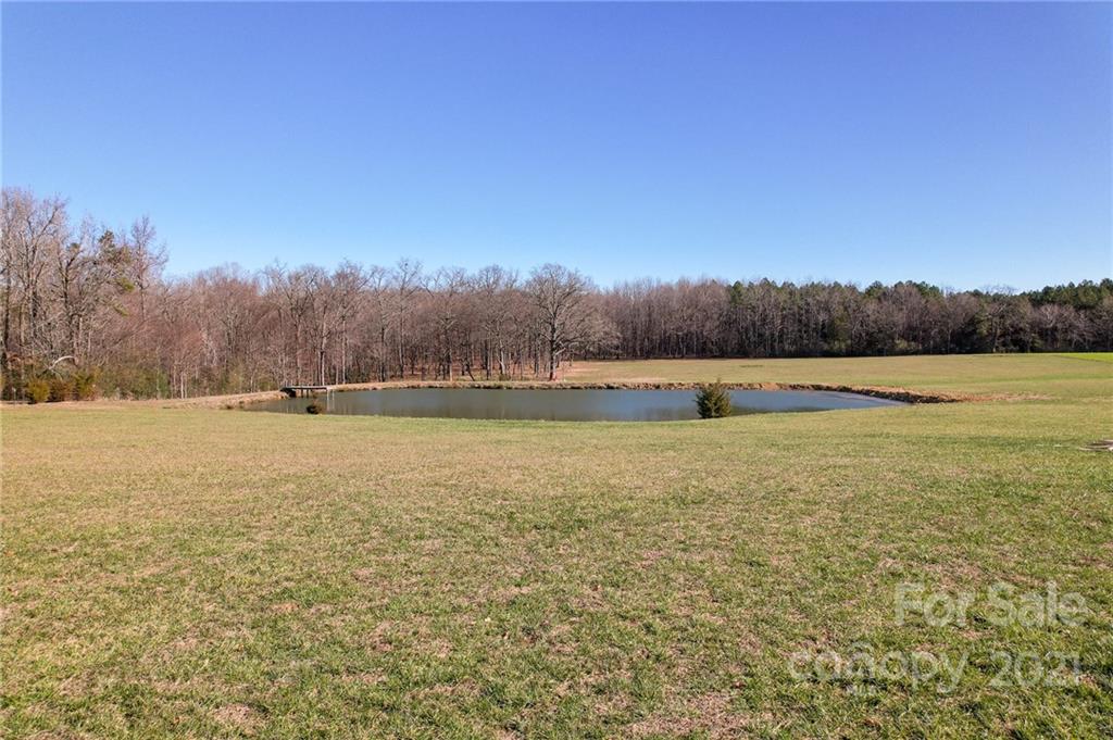 4515 Belk Mill Road Monroe, NC 28112 - Photo 8 of 12 a view of outdoor space with yard and trees in the background