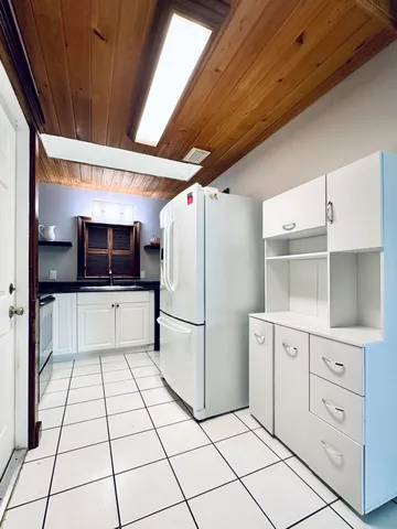 a kitchen with a refrigerator a stove and cabinets