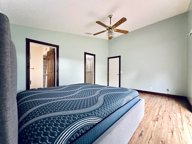 a bedroom with a large bed and a window