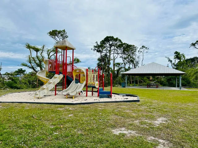 a view of a backyard with a table and chairs