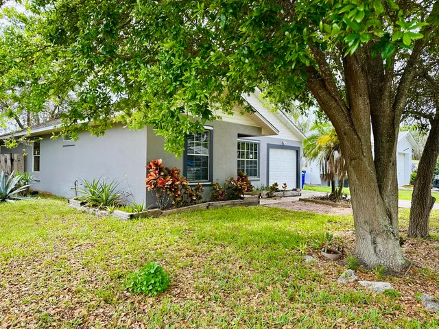 a view of a house with swimming pool and sitting area