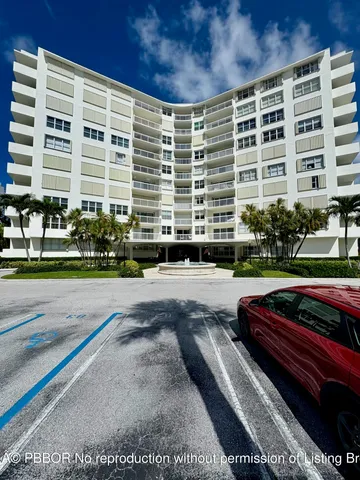 a front view of a building with a garden
